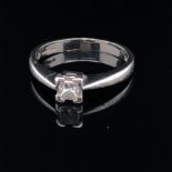 A PLATINUM AND DIAMOND SINGLE STONE RING. THE PRINCIPLE DIAMOND A PRINCESS CUT IN A FOUR CLAW CORNER