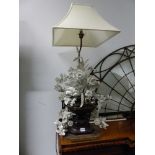 A PAIR OF TABLE LAMPS WITH WOODEN URN BASES FILLED WITH WHITE COMPOSITION FLOWERS BELOW SQUARE