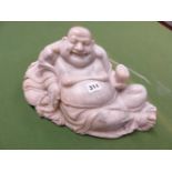 A CHINESE GREY GREEN SOAPSTONE CARVING OF BUDAI SMILING AS HE RECLINES ON HIS SACK OF POSSESSIONS, A