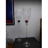 TWO OUTSIZE WINE GLASSES, THE CLEAR TULIP BOWLS ON STEMS AND CIRCULAR FEET. H 122cms.