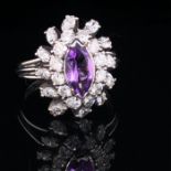 A PLATINUM AMETHYST AND DIAMOND CLUSTER RING. THE CENTRAL MARQUIS CUT AMETHYST SURROUNDED BY A