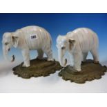 A PAIR OF ANTIQUE GERMAN PORCELAIN ELEPHANTS STANDING ON LATER ORMOLU BASES. W 26cms.