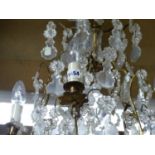 A FIVE LIGHT FRENCH CHANDELIER, THE THREE BRASS TIERS HUNG WITH CLEAR GLASS LEAF SHAPES PENDANT FROM