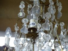 A FIVE LIGHT FRENCH CHANDELIER, THE THREE BRASS TIERS HUNG WITH CLEAR GLASS LEAF SHAPES PENDANT FROM