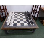 A GREY AND WHITE MARBLE STAUNTON SHAPED CHESS SET, THE KINGS. H 22.5cms. TOGETHER WITH A CHESS BOARD