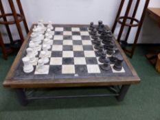 A GREY AND WHITE MARBLE STAUNTON SHAPED CHESS SET, THE KINGS. H 22.5cms. TOGETHER WITH A CHESS BOARD