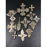 A GROUP OF TEN ETHIOPIAN COPTIC CROSS PENDANTS OF VARIOUS DESIGNS AND STYLES, ONE SUSPENDED ON A