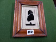 A PORTRAIT SILHOUETTE, REVERSE PAINTED ON GLASS INSCRIBED THOMAS TOMPION 1710, MOUNTED IN A 19TH