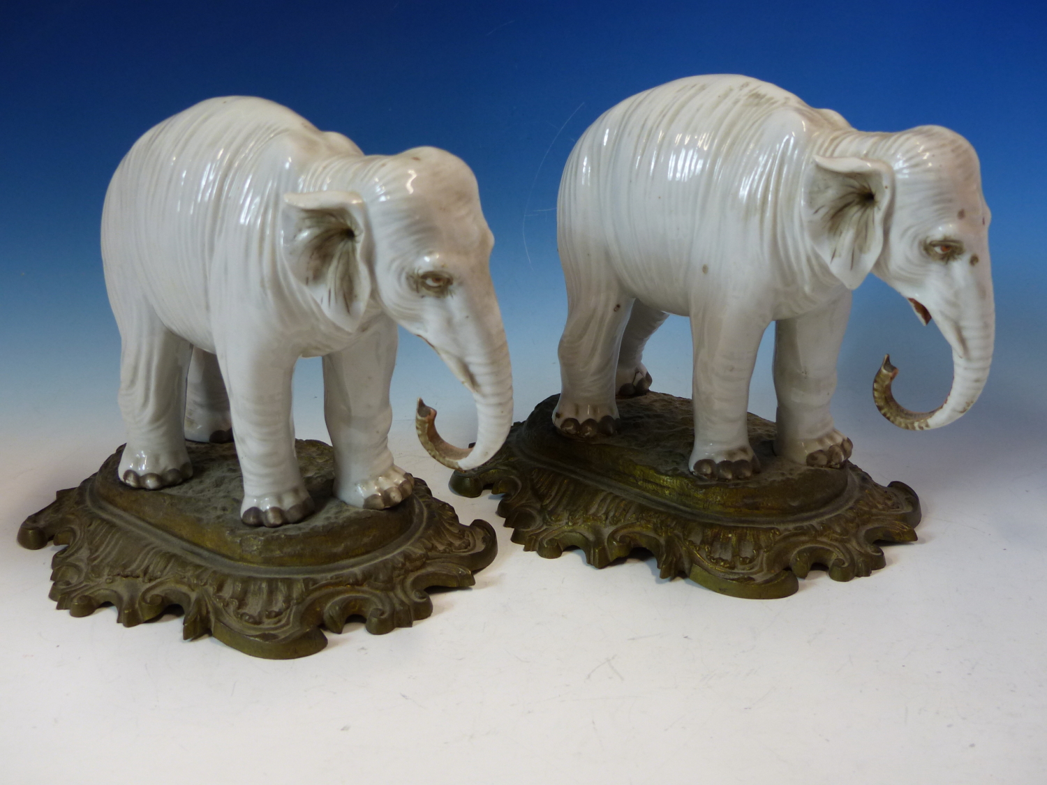 A PAIR OF ANTIQUE GERMAN PORCELAIN ELEPHANTS STANDING ON LATER ORMOLU BASES. W 26cms. - Image 4 of 8