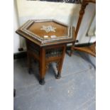 AN ISLAMIC HEXAGONAL TABLE CENTRALLY INLAID WITH MOTHER OF PEARL SIX POINT STAR, THE EBONISED