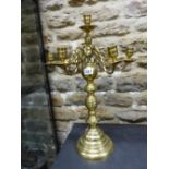 A BRASS SEVEN LIGHT CANDELABRUM, THE BRANCHES SCROLLING FROM A TURNED COLUMN ON CIRCULAR FOOT. H