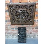 A BURMESE CARVED HARDWOOD PANEL, THE CENTRAL SCENE OF FIGURES BY A BUILDING WITHIN FOLIAGE AND