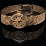 A LADIES 9ct GOLD VINTAGE OMEGA WATCH, ON AN INTEGRAL MILANESE 9ct GOLD BRACELET WITH A LADDER