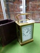 A LEATHER CASED CARRIAGE CLOCK STRIKING ON A COILED ROD. H 15cms.