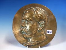 A BRONZE ROUNDEL WITH THE HEAD OF A MOUSTACHIOED MAN IN RELIEF, POSSIBLY LORD KITCHENER. Dia. 26.