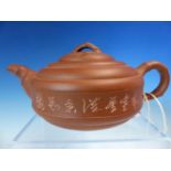 A YIXING RED WARE TEA POT, THE CAVETTO SIDES INCISED WITH CHARACTERS, FOUR CHARACTER SEAL MARK ON