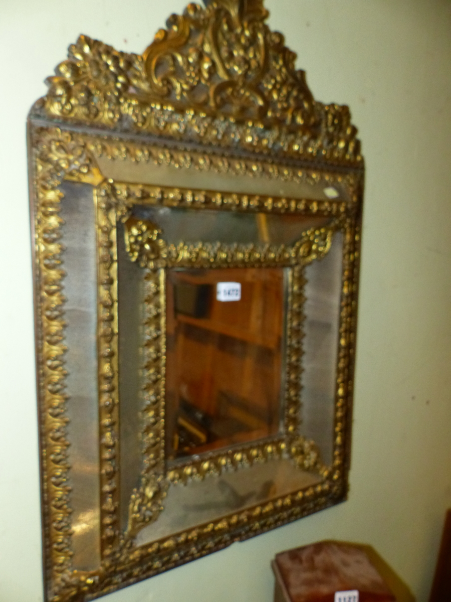 A DUTCH BAROQUE STYLE BRASS MOUNTED MULTIPLE PLATE MIRROR CRESTED BY FRUIT, FLOWERS AND SCROLLING