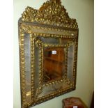A DUTCH BAROQUE STYLE BRASS MOUNTED MULTIPLE PLATE MIRROR CRESTED BY FRUIT, FLOWERS AND SCROLLING