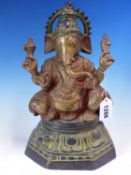 AN INDIAN RED TINTED BRONZE FIGURE OF GANESH HOLDING ATTRIBUTES IN HIS FOUR HANDS AS HE SITS ON A