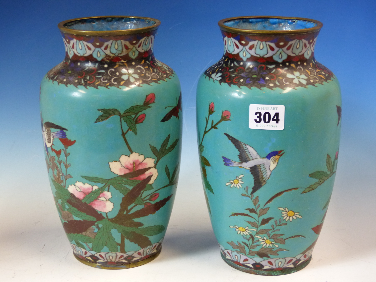 A PAIR OF JAPANESE CLOISONNE VASES WORKED WITH BIRDS AND FLOWERS ON A GREEN TURQUOISE GROUND. H