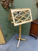 A REGENCY STYLE ADJUSTABLE DUET MUSIC STAND WITH TWIN CANDLE SCONCES.