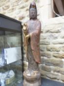 A CARVED WOOD FIGURE OF GUANYIN, HER RED AND BLUE ROBES GILT WITH SCROLLING LOTUS AS SHE STANDS WITH