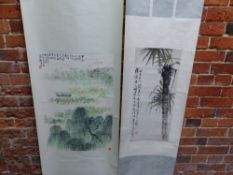 TWO CHINESE SCROLL PAINTINGS, ONE OF A BOAT AMONGST LOTUS ON A LAKE BELOW WILLOW TREES. 69.5 x