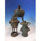 TWO CHINESE BRONZE CENSERS AND A VASE EACH WITH COVERS, THE TALLEST. H 20cms.