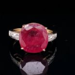 A 9ct YELLOW GOLD, RED GEMSTONE AND DIAMOND SET DRESS RING. FINGER SIZE N. WEIGHT 3.9grms.