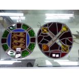 TWO LEADED GLASS ROUNDELS: THE LIONS OF ENGLAND. Dia. 28.5cms. AND CROSSED SCEPTRES ON A RED GROUND.