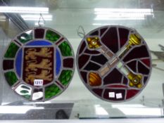 TWO LEADED GLASS ROUNDELS: THE LIONS OF ENGLAND. Dia. 28.5cms. AND CROSSED SCEPTRES ON A RED GROUND.