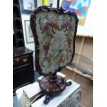 A 19th C. ROSEWOOD POLE SCREEN, THE SHAPED FRAME CONTAINING FLORAL NEEDLEWORK, THE COLUMN ON