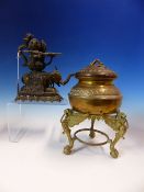 AN INDIAN BRONZE TRIPLE LIGHT OIL LAMP WITH NAGA HANDLE AND SUPPORTED ON THE BACK OF AN ELEPHANT.