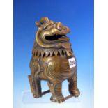 A CHINESE BRONZE INCENSE BURNER IN THE FORM OF A BUDDHIST LION, FOUR CHARACTER MARK ON ITS BELLY.