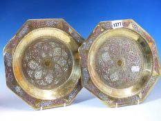 A PAIR OF BRASS OCTAGONAL PLATES DAMASCENED IN SILVER AND COPPER. W 25cms. A COPPER COFFEE POT