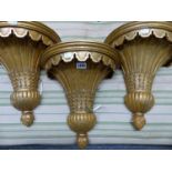 THREE GILT COMPOSITION WALL LIGHTS, EACH CAST WITH A DEMILUNE OF PALM LEAVES TAPERING TO A