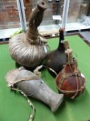 A TURKANA CAMEL HIDE BUTTER CONTAINER AND WOODEN CUP COVER. H 35cms. TWO KENYAN WATER GOURDS AND A