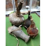 A TURKANA CAMEL HIDE BUTTER CONTAINER AND WOODEN CUP COVER. H 35cms. TWO KENYAN WATER GOURDS AND A