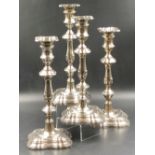 A SET OF FOUR HALLMARKED SILVER WEIGHTED BASE CANDLESTICKS, COMPLETE WITH REMOVABLE DRIP PANS, DATED