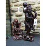 TWO CHINESE CARVED HARDWOOD FIGURES, ONE OF A SKINNY MAN SEATED. H 28cms. THE OTHER OF A