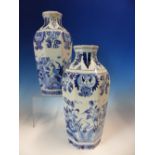 A PAIR OF DELFT BLUE AND WHITE OCTAGONAL VASES PAINTED WITH PEACOCKS AMONGST FLOWERS, JV MARKS. H