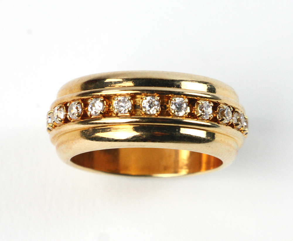 14k gold and diamond band, approximately 7 grams TW, size 6 1/2. Provenance: From a Winchester,