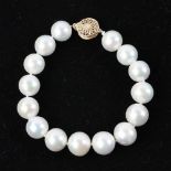 Graduated South Sea pearl bracelet, with 14k gold clasp, approximately 11 to 13 mm, 7" L.