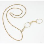 Antique gold lorgnette with 24" L necklace, approximately 31 grams TW. Provenance: From a Beverly