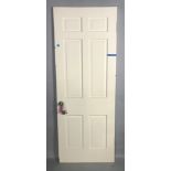 White painted wood panel door, 79" H x 29 3/4" W x 1 3/4" D. Provenance: Studio Props of Martha