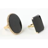 Two 10k gold onyx rings, approximately 16 grams TW, sizes 8 and 6 1/2. Provenance: From a