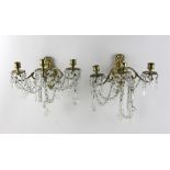 Pair of French ormolu and crystal wall sconces, 11" H x 12" W x 8" D. Provenance: Mrs. Auto of