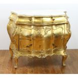 Venetian gold leaf bombe chest with white marble top, 34" H x 41" W x 20" D. Provenance: From a