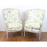 Pair of Louis XVI-style carved upholstered high back chairs, 42" H x 27" W x 24" D. Provenance: From