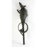 Bronze sculpture of mask, plane and horn, 34" H x 9" W. Provenance: From an Everett, Massachusetts